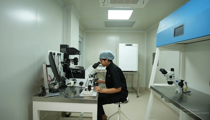 Embryologist working with a microscope inside an advanced IVF laboratory.